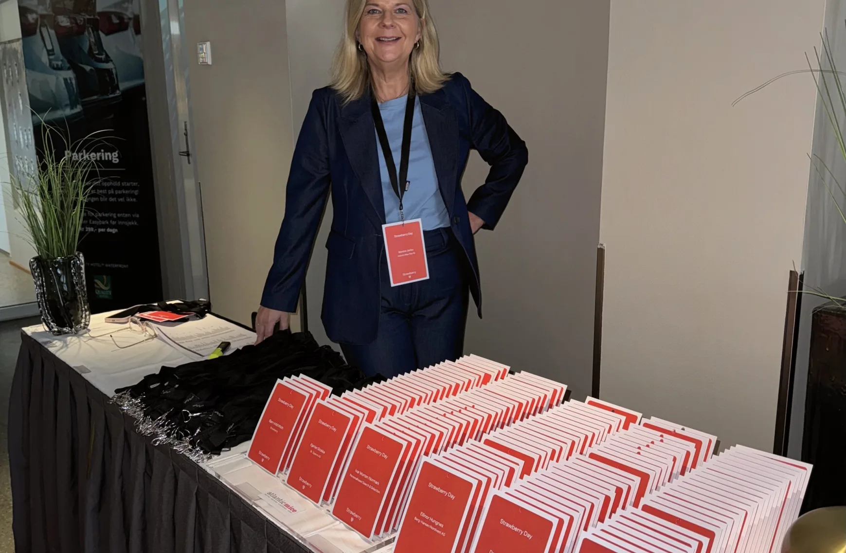 Foto av Monica Janbu som står ved deltakerkort